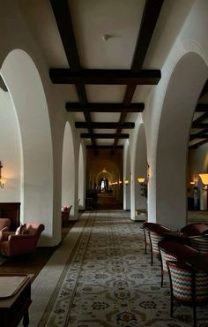 a long hallway with couches and tables in it