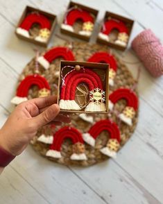 a person holding up a box with some decorations in it