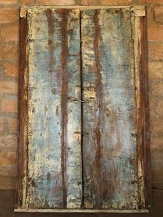 an old wooden door with peeling paint on it