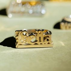 Enhance your style with our exquisite handcrafted Old English Name Ring. Customize it today to reflect your unique taste. Each ring is expertly crafted for you, featuring your chosen text in a distinctive Old English font. Customize your ring with up to 8 Letters, Numbers, or Roman Numerals. Select from ring sizes 4 to 14 for an ideal fit. Enhance your style with our exquisite Old English Name Ring, infusing a hint of uniqueness into your appearance. Customizable 14k Gold Promise Jewelry, Customizable 14k Gold Jewelry For Promise, Customizable Nameplate Jewelry For Promise, Customizable Yellow Gold Jewelry For Promise, Custom Name Engraved Yellow Gold Ring, Custom Name 14k Gold Rings For Personalized Gift, Customizable 14k Gold Nameplate Ring, 14k Gold Jewelry With Engraved Text, Personalized 14k Gold Rings With Custom Name