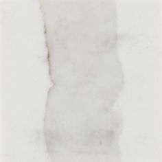 a piece of white marble with brown streaks