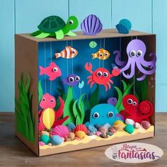 an ocean scene made out of cardboard with sea animals and fish on the bottom shelf