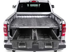 the back end of a silver truck with its cargo compartment open