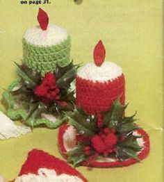 two crocheted candles sitting next to each other on top of a green table