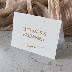 a card that says cupcakes and brownies next to a pile of blankets