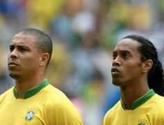 two soccer players standing next to each other