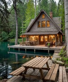 a house sitting on top of a wooden dock next to a forest filled with trees