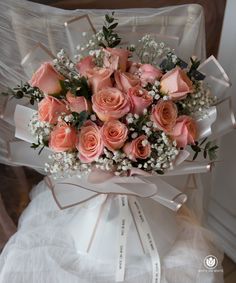 a bouquet of pink roses and baby's breath