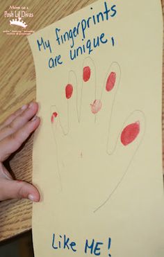 someone holding up a piece of paper that says, my fingerprints are unique like me