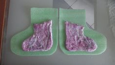 two pieces of felt sitting on top of a green mat