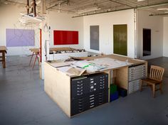 an empty room with lots of drawers and desks