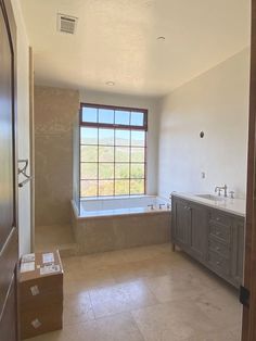 a large bathroom with two sinks and a tub