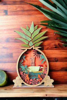 a pineapple cutout sitting on top of a wooden shelf