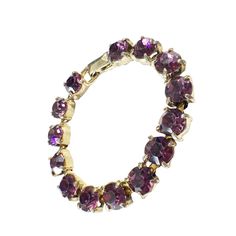 This vintage women's tennis bracelet showcases a 14+ carat purple amethyst gemstone, which has been lab-created and is perfectly round in shape. The gemstone is set in a gold tone metal with slight signs of wear, stone with minor loss,, but is still in overall good condition. Measuring 6.75 inches in length and 0.25 inches in height. Purple Jewelry With Jubilee Bracelet For Anniversary, Elegant Round Amethyst Crystal Bracelet, Elegant Purple Amethyst Tennis Bracelet, Elegant Amethyst Bracelet, Purple Jubilee Tennis Bracelet, Classic Amethyst Bracelets In Purple, Formal Amethyst Gemstone Tennis Bracelet, Classic Amethyst Purple Bracelets, Amethyst Tennis Bracelet As A Gift