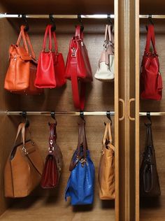 the purses are lined up on the shelves in the closet, and ready to be used