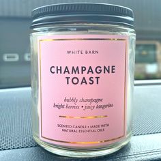 a jar of champagne toast sitting on top of a car dash board next to a window