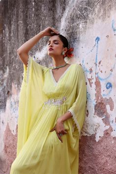 Step into effortless elegance with this full-length draped kaftan adorned with intricate embellishments. This kaftan offers a perfect balance of style and comfort, making it ideal for both casual outings and special occasions. Embrace luxury and grace with this stunning piece that's sure to turn heads wherever you go. Festive Bollywood V-neck Maxi Dress, Summer Festive V-neck Kaftan, Summer Anarkali Style Floor-length Kurta, Green Maxi Length Kaftan For Festivals, Green Maxi-length Kaftan For Festivals, Elegant Green Georgette Kaftan, Embellished Floor-length Green Kaftan, Bollywood Style Festive Summer Maxi Dress, Summer Festive Bollywood Maxi Dress