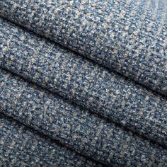 three pieces of blue and grey tweed fabric with small squares on the top, one is folded