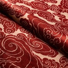 a red and white fabric with swirls on it