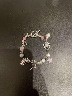 A beautiful pink bracelet with cute charms and more! Trendy Pink Metal Bracelet, Trendy Pink Metal Bracelets, Trendy Pink Beaded Bracelets With Charms, Cute Metal Charm Bracelet, Trendy Pink Jewelry With Charms, Trendy Pink Charm Bracelets, Trendy Pink Bracelets With Charms, Cute Dangle Charm Bracelet, Sweet Pink Dangle Jewelry