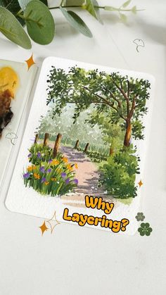 a card with an image of a park and trees on it next to some flowers