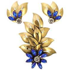 Fabulous Joseff of Hollywood gold plated large flower and cut out leaves brooch, and clip-on earrings set. Featuring dazzling cobalt blue marquise and round clear crystals. The brooch measures 11cm / 4.3 inches by 7.6cm / 3 inches, and the earrings are length 4.8cm / 1.9 inches by width approximately 4.8cm / 1.9 inches. This is a stunning Joseff statement set with brilliant blue crystals from the 1950s. A rare find. Homemade Jewelry Cleaner, Woman Jewelry, Laser Welding, Homemade Jewelry, Crystal Brooch, Stone Setting, Jewelry Unique, Clear Crystals, Jewelry Cleaner