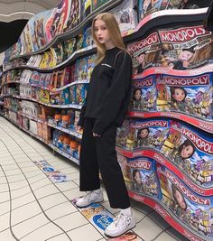 a woman standing on top of a skateboard in front of a store filled with magazines