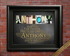 the word anthony written in different languages on a black frame against a red brick wall