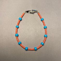 Introducing our Navajo-inspired beaded bracelet, where vibrant salmon hues complement faux turquoise accents. Handcrafted with care by a Navajo artisan, this bracelet is a celebration of color and tradition. Measuring 16cm, it's designed to add a touch of Navajo elegance to any outfit. Embrace the beauty of Navajo craftsmanship with this stunning beaded bracelet--a unique piece that effortlessly combines vibrant colors with cultural pride. Traditional Turquoise Beaded Bracelets With Colorful Beads, Southwestern Style Orange Jewelry With Colorful Beads, Southwestern Style Hand-strung Beaded Bracelet, Southwestern Turquoise Nickel-free Beaded Bracelets, Southwestern Style Blue Hand-strung Beads, Turquoise Accents, Salmon Color, Unique Pieces, Beaded Jewelry