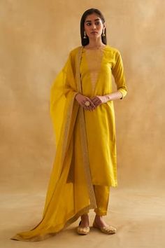 Mustard yellow kurta with bird and botanical motif embroidery in katan silk base. Paired with a cigarette pant and pure Indian organza dupatta with an embroidered border. - Aza Fashions