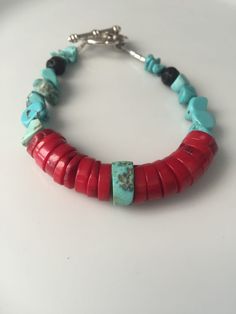 Red coral heishi bracelet with turquoise and lava rock.  In this bracelet I used large pieces of red coral. For the Mexica, red coral is symbolic of female fertility.  Coral can also helps with blood conditions.   Every piece of jewelry I make for myself is finished with a lava rock and 3 pieces of turquoise at the end of each strand. The Mexica acknowledge lava rocks as our ancestors. They remind us of the knowledge and wisdom that our ancestors carried which we also carry as we are connected to them.  Turquoise is a protective stone that protects against energy that does not belong to you.  This piece is also finished with lava rock and turquoise, sharing with you the intention of the strength and wisdom of your ancestors. the bracelet you receive will vary slightly from the one pictured Unique Hand-strung Red Beaded Bracelets, Red Heishi Beads Jewelry For The Beach, Handmade Red Heishi Beads Jewelry, Unique Hand-strung Red Bracelets, Red Bohemian Bracelet With Natural Stones, Bohemian Red Bracelet With Natural Stones, Handmade Southwestern Red Beaded Bracelets, Southwestern Style Red Beaded Bracelets For Gift, Southwestern Style Red Beaded Bracelet As Gift