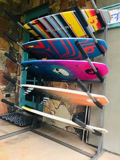 there are many surf boards on the rack