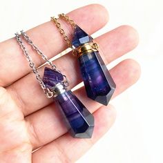 two amethyst necklaces are being held in the palm of someone's hand