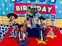 toy story birthday party decorations with woody and buzz the cowboy on red table cloths