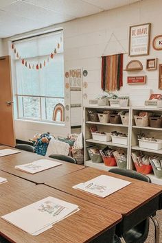 an empty classroom with desks and bookshelves