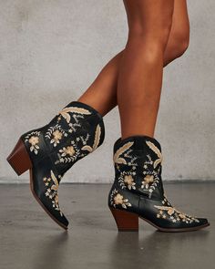 Combine the rugged spirit of Western wear with a chic, feminine twist with the Full Bloom Embroidered Floral Western Bootie. Crafted for the modern cowgirl, these booties boast intricate embroidered floral designs that add a touch of romance and a pointed toe that bring a sleek silhouette, perfect for pairing with denim or a flowy dress. Slip-on styling with convenient pull tabs ensures you’re ready to go, whether you’re heading out for a brunch date or a casual stroll through the city. Heel Height: 2.5" Shaft Height: 7" True to size Slip-on styling with pull tabs Material: Vegan Leather Womens Cowgirl Boots Floral, Low Cowgirl Boots, Cowgirl Silhouette, Modern Cowgirl, Western Wear Dresses, Boho Cowgirl, Dress Slip, Western Booties, Dresses By Length