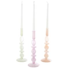 three different colored candles sitting next to each other