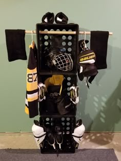 a hockey goalie's helmet and glove rack in the corner of a room