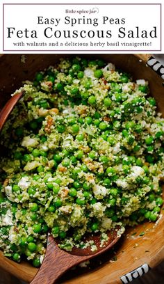 a wooden bowl filled with peas and feta couscous salad on top of a table