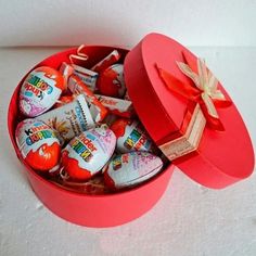 an open heart shaped box filled with candy