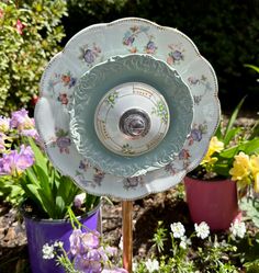 a close up of a plate on a stand in a garden