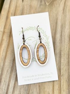 the earrings are made out of wood and have an oval design on each earring