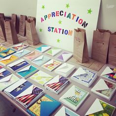 there are many cards on the table and bags next to them that say appreciation station