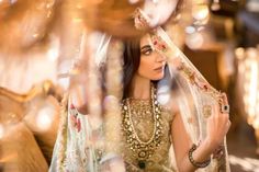 a woman wearing a bridal outfit and veil