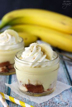 two desserts in small glass jars with whipped cream on top