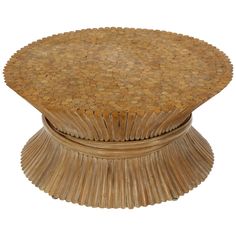 a round wooden table with an intricate design on the top and bottom, made out of wicker