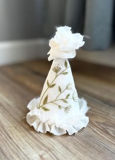 a small white flower on top of a wooden table