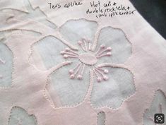 a close up of a piece of cloth with embroidered flowers on the bottom and sides