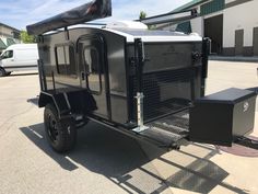 a black trailer parked in a parking lot