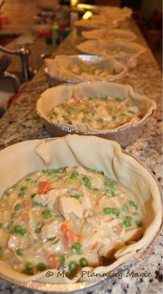 three pie pans filled with food on top of a kitchen counter next to each other